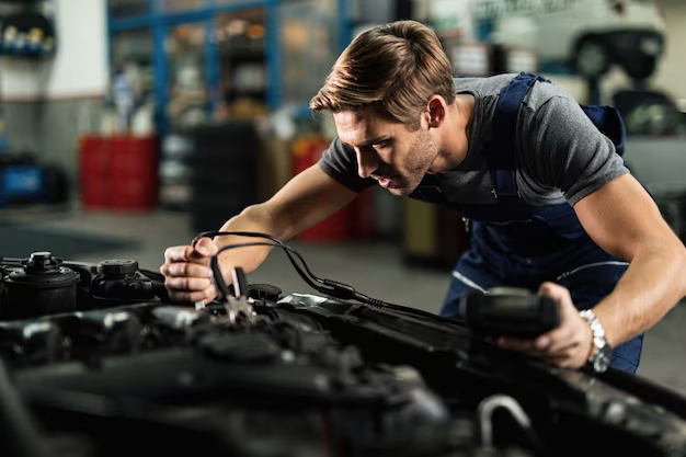 Mechanic uses diagnostic tool to check car